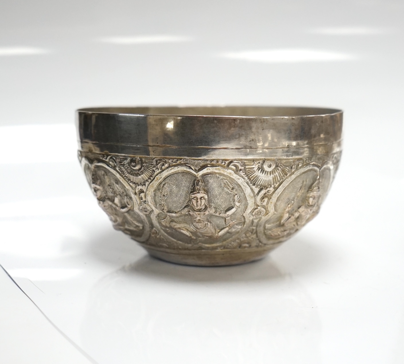 Three Malaysian or Indonesian white metal ashtrays, largest diameter 12.5cm, a similar dish and a bowl. Condition - poor to fair